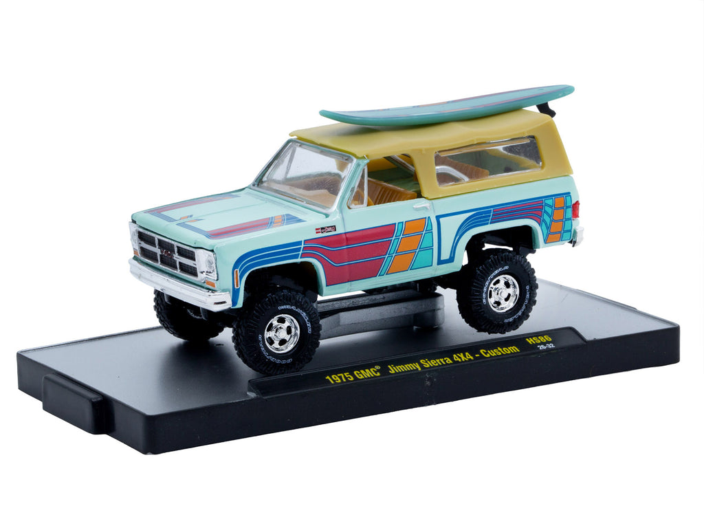 1975 GMC Jimmy Sierra 4x4 Light Blue with Graphics and Tan Top with Surfboard Limited Edition to 10560 pieces Worldwide 1/64 Diecast Model Car by M2 Machines - image 2
