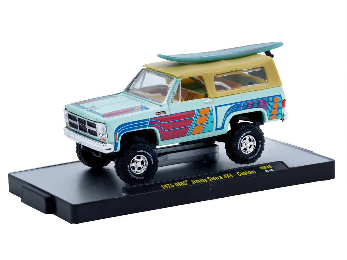 1975 GMC Jimmy Sierra 4x4 Light Blue with Graphics and Tan Top with Surfboard Limited Edition to 10560 pieces Worldwide 1/64 Diecast Model Car by M2 Machines - image 2