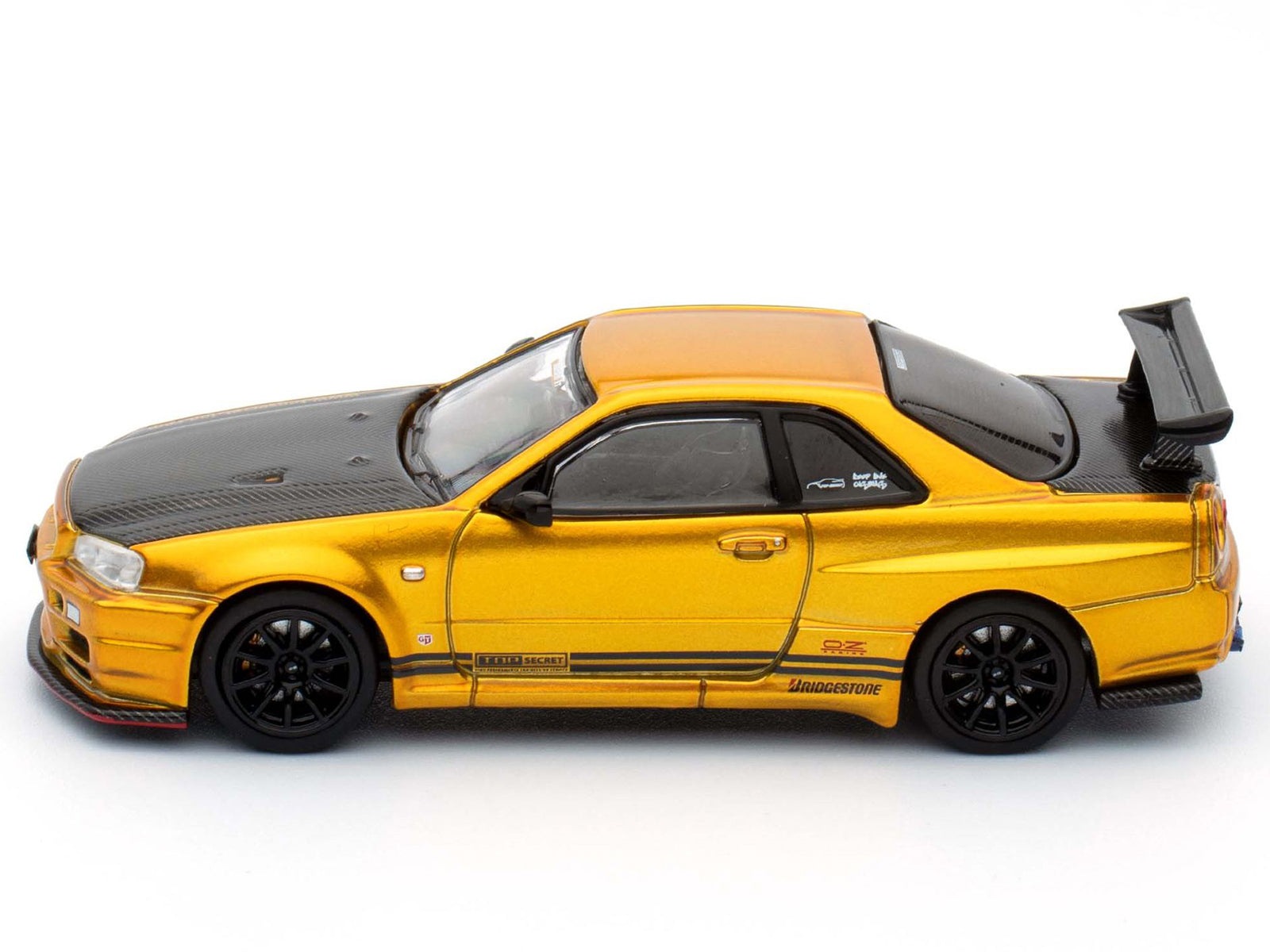Nissan Skyline GT-R (R34) "Top Secret" RHD (Right Hand Drive) Gold Metallic with Carbon Hood and Trunk "Tokyo Auto Salon 2024 - Malaysia Diecast Expo 2024" 1/64 Diecast Model Car by Inno Models - image 2